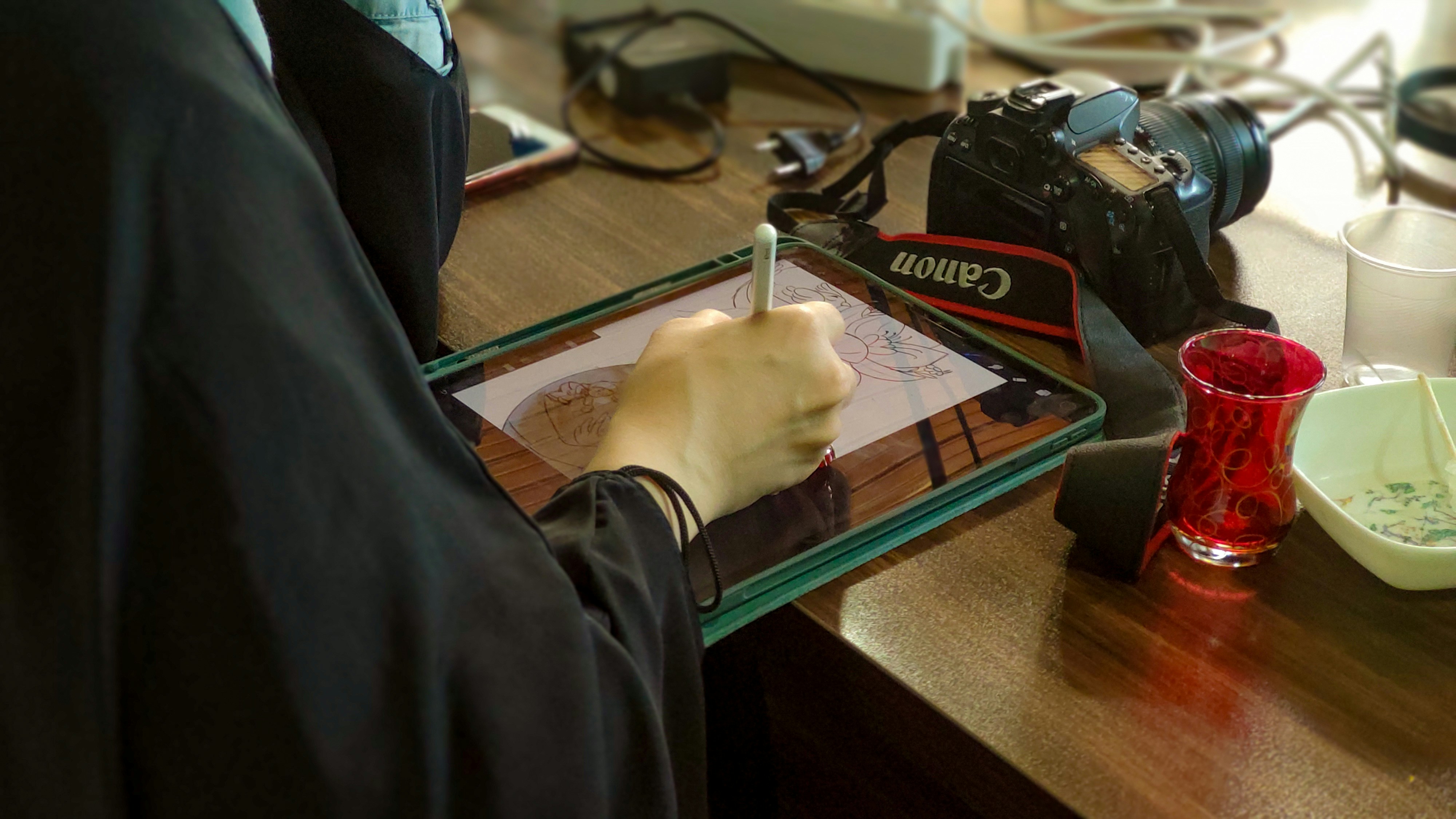 A graffiti artist using a digital tablet to create intricate designs.