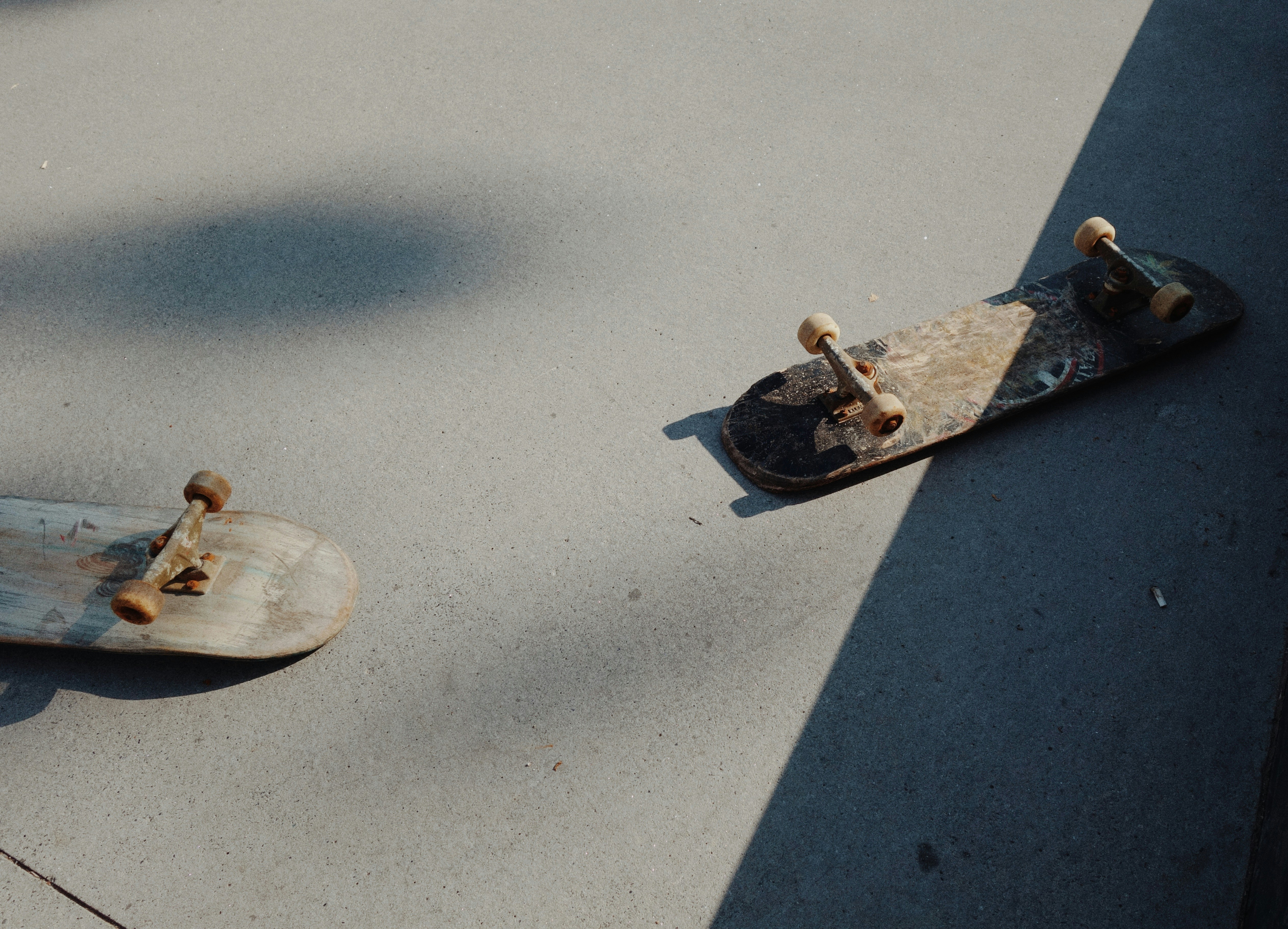 Two skateboards on the ground.