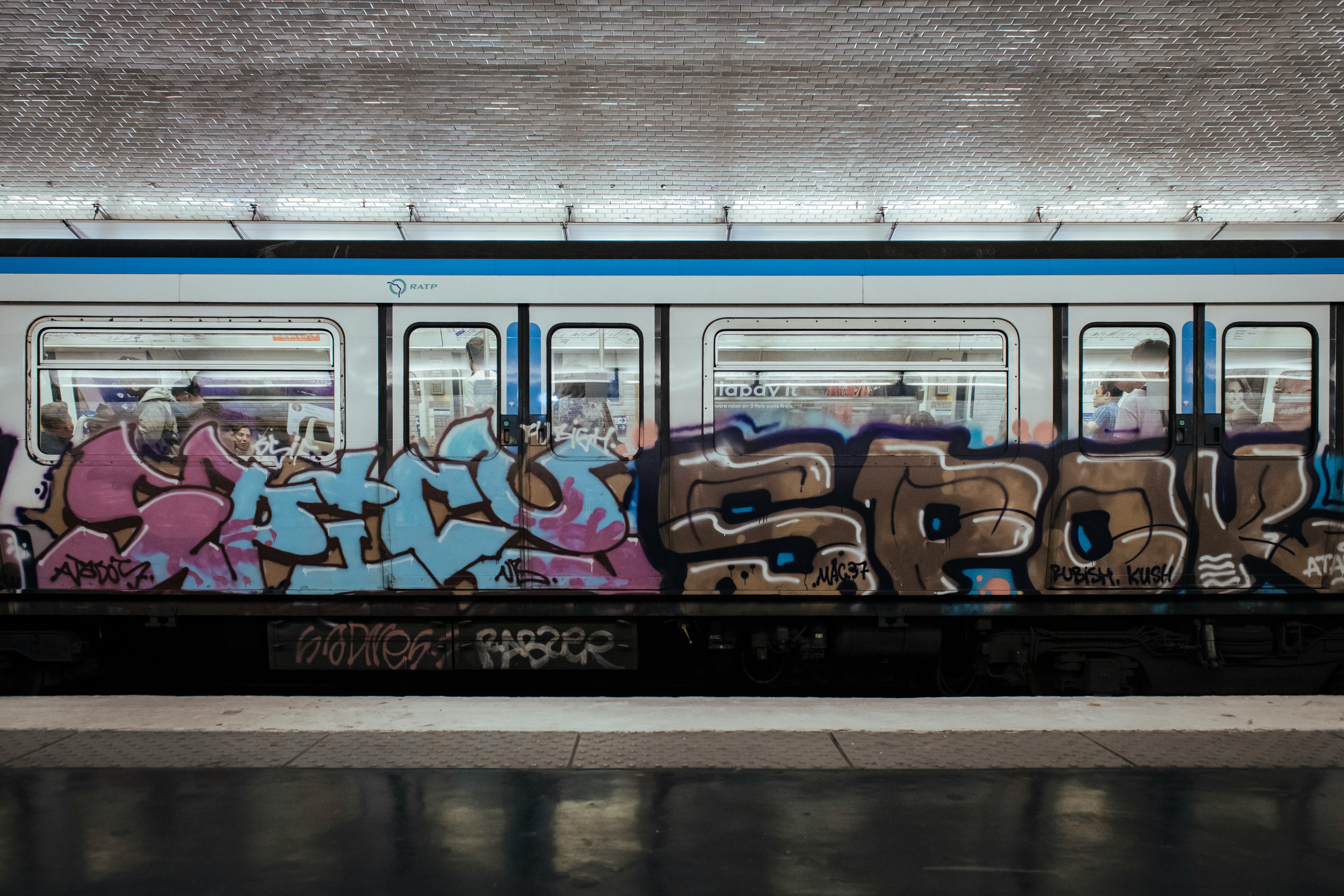 A subway car covered in graffiti art.